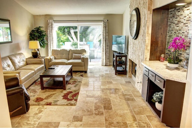 living room with a large fireplace and a healthy amount of sunlight