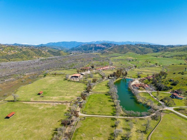 aerial view with a water and mountain view and a rural view