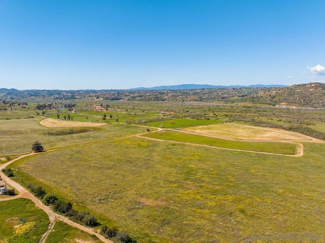 birds eye view of property with a mountain view and a rural view