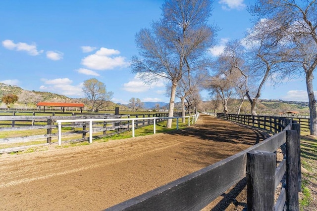 view of yard featuring a rural view and a mountain view