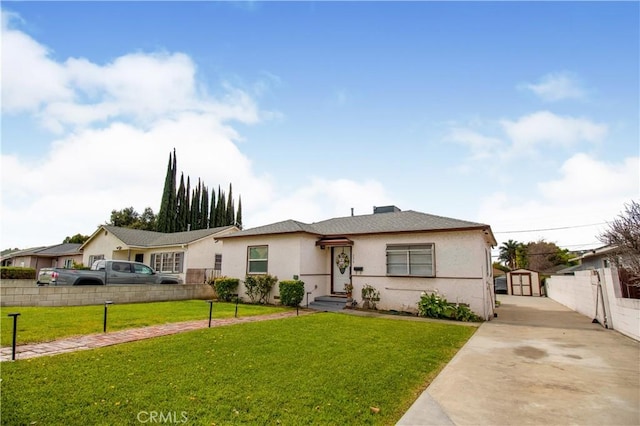 ranch-style house with a front yard and a storage unit