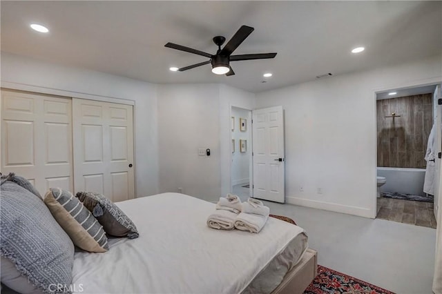 bedroom with a closet, ensuite bath, and ceiling fan