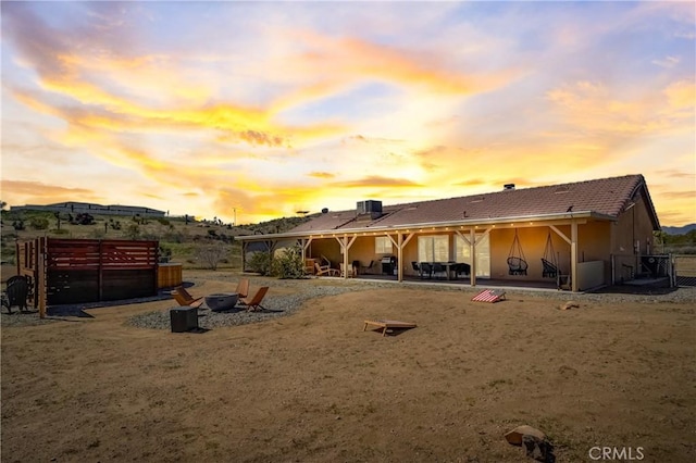 view of back house at dusk