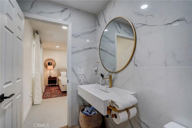 bathroom with tile walls