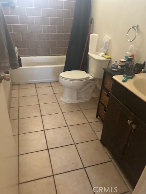 full bathroom with tile flooring, shower / tub combo with curtain, toilet, and vanity