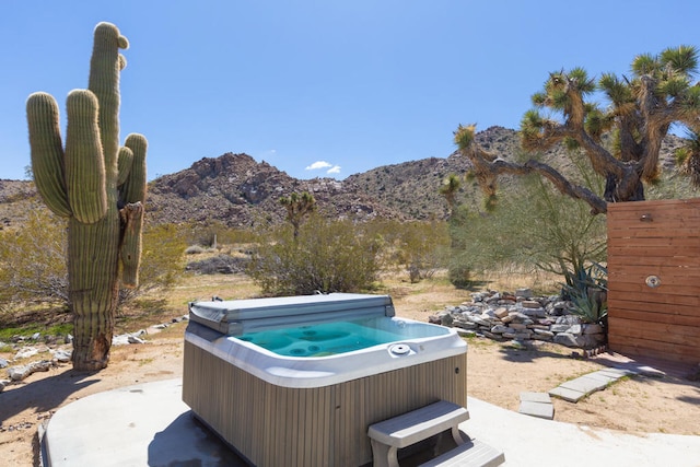 exterior space featuring a hot tub and a mountain view