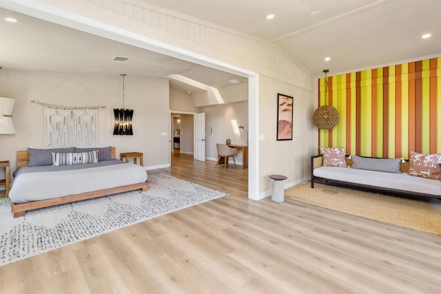 bedroom with light hardwood / wood-style flooring and lofted ceiling