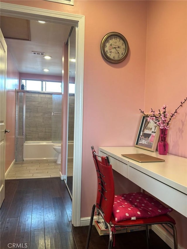 interior space featuring tiled shower / bath, vanity, toilet, and hardwood / wood-style floors