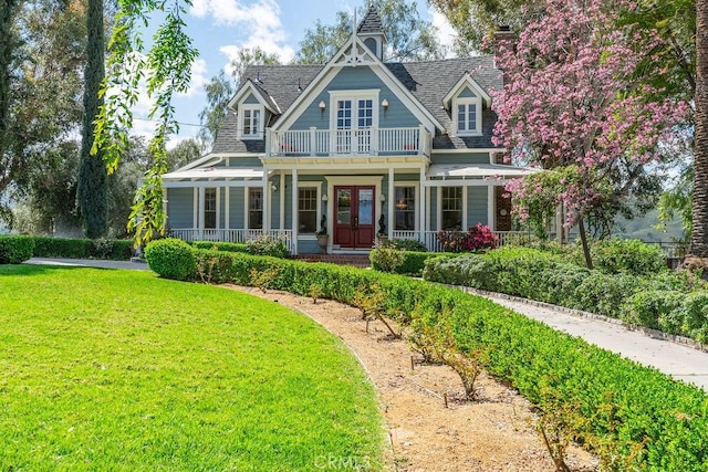 view of front of house with french doors and a front lawn