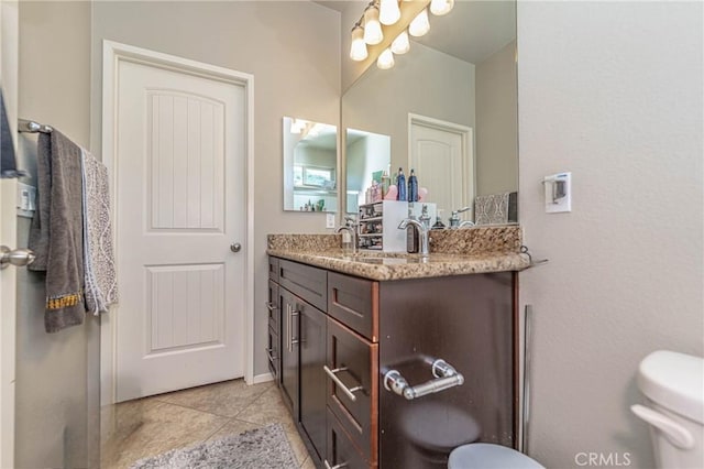 bathroom with tile patterned floors, vanity, and toilet