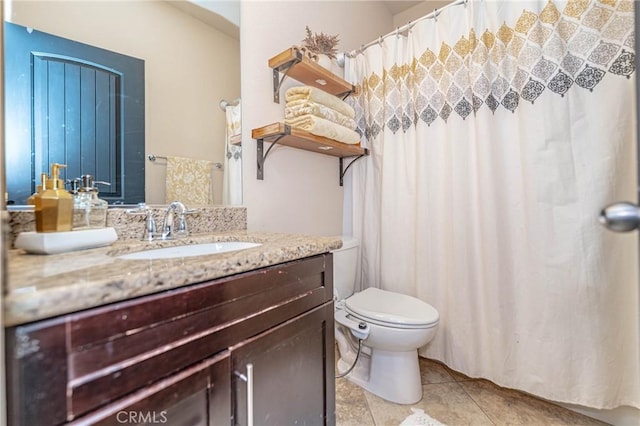 bathroom featuring toilet, vanity, and tile patterned floors