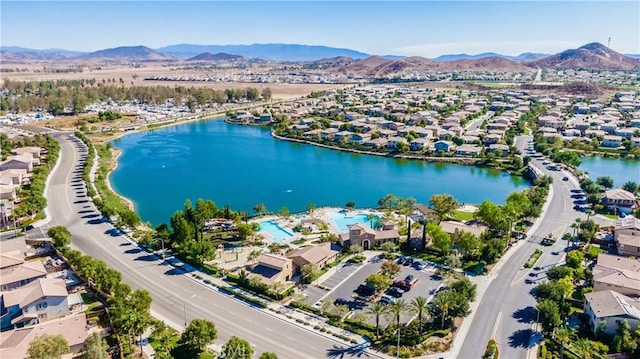 drone / aerial view with a water and mountain view