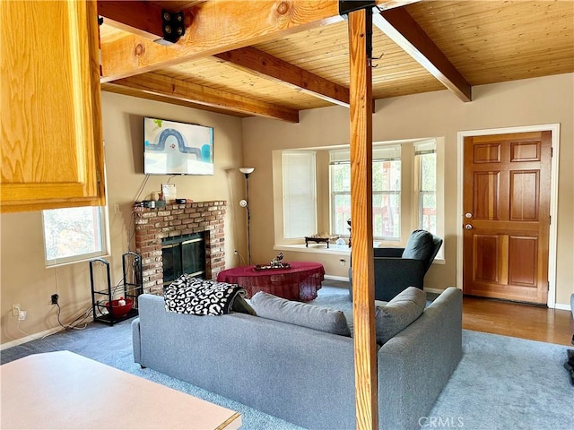 living room with beam ceiling, hardwood / wood-style flooring, wooden ceiling, and a brick fireplace