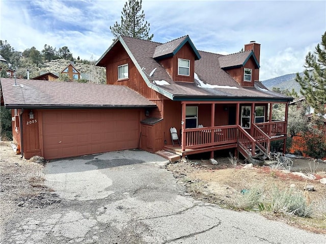 2005 Zermatt Dr, Pine Mountain Club, CA 93222 - chalet / cabin with a chimney, a porch, an attached garage, and driveway