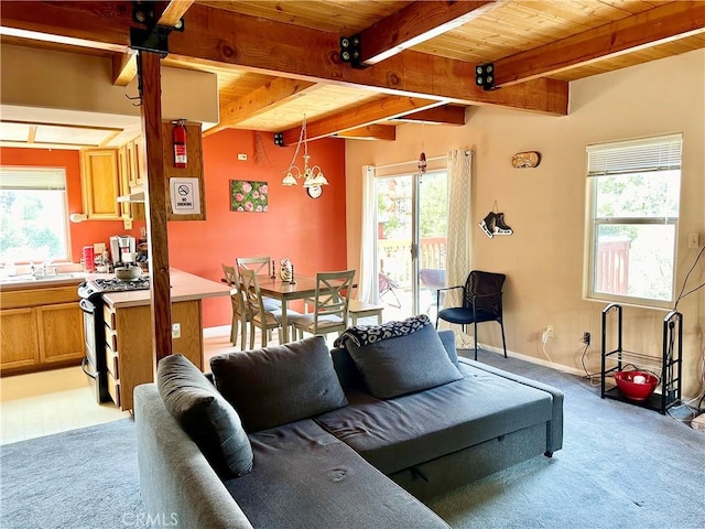 living room with light carpet, plenty of natural light, wooden ceiling, and a notable chandelier