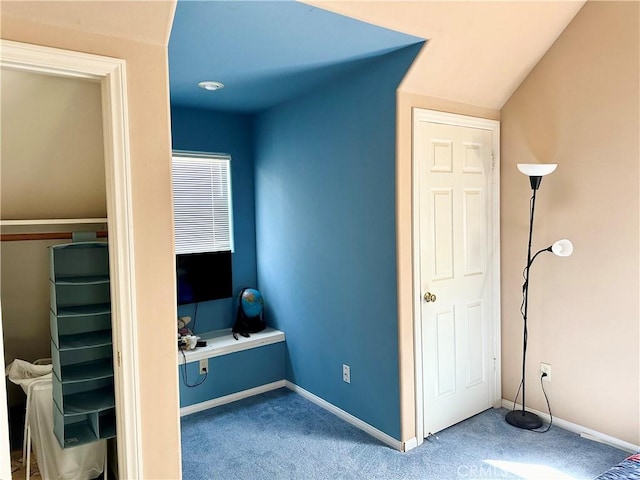 bedroom with carpet flooring and lofted ceiling