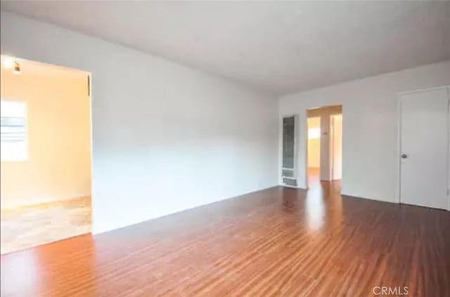 unfurnished room with dark hardwood / wood-style floors