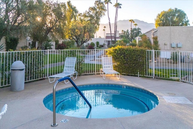 pool at dusk with a mountain view and a patio