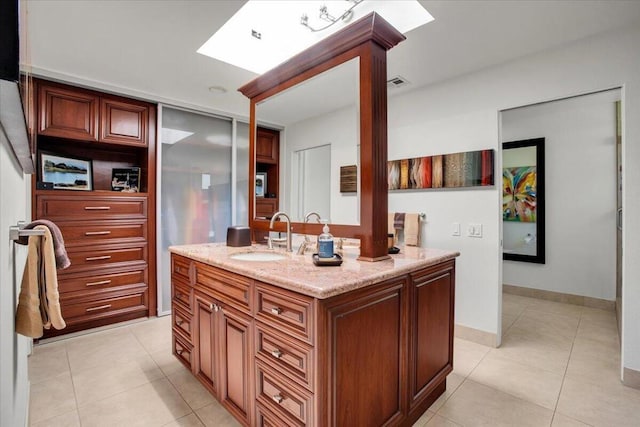 bathroom with vanity and tile patterned flooring