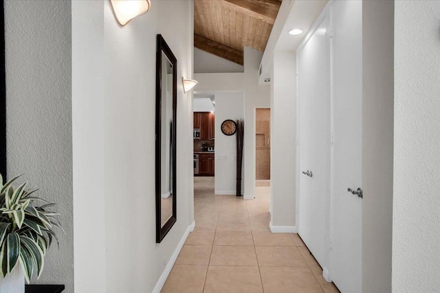 hallway featuring light tile patterned floors, lofted ceiling with beams, and wood ceiling