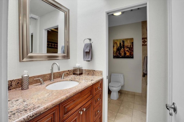 bathroom featuring tile patterned floors, vanity, and toilet