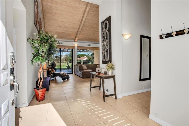 tiled entryway featuring beam ceiling, high vaulted ceiling, and wooden ceiling