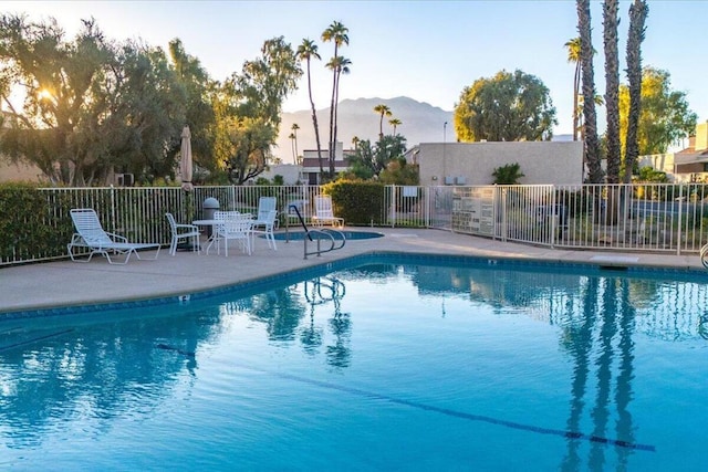 view of swimming pool with a mountain view and a patio