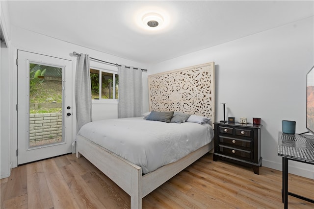 bedroom featuring access to outside and light hardwood / wood-style flooring