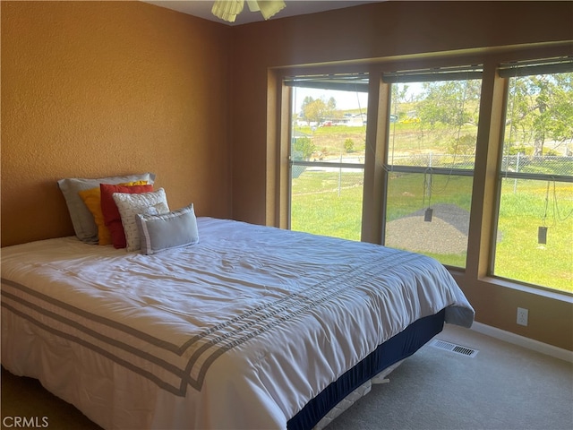 carpeted bedroom featuring ceiling fan