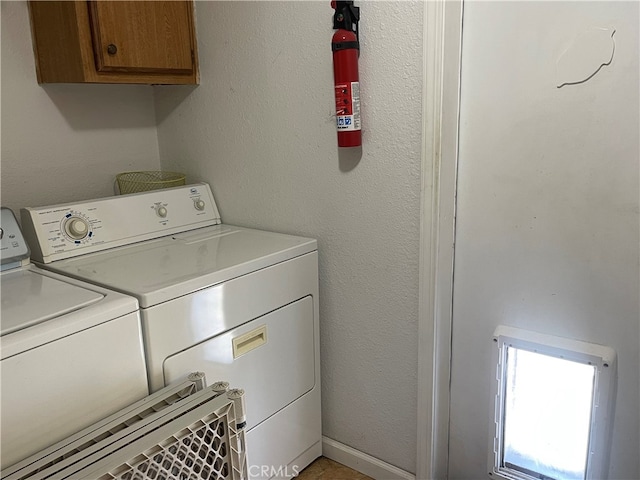 laundry room with cabinets and independent washer and dryer