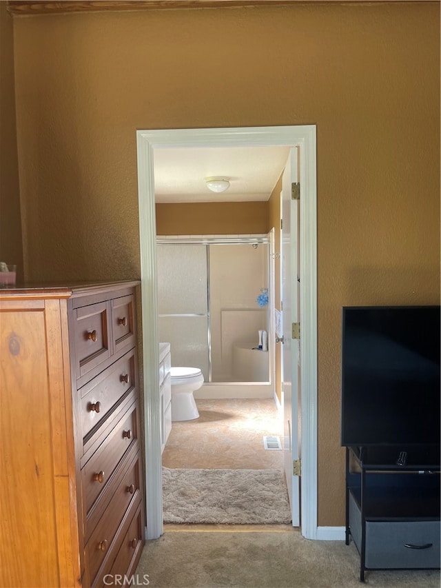 bathroom with toilet and walk in shower