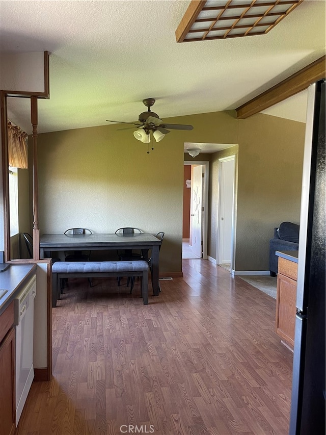 interior space featuring ceiling fan, hardwood / wood-style floors, beamed ceiling, and a textured ceiling