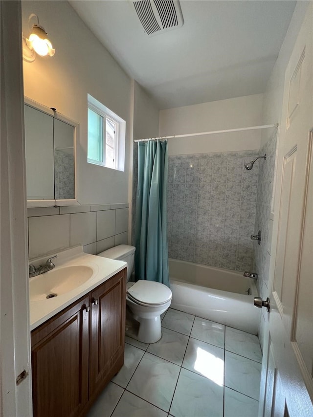 full bathroom featuring shower / tub combo with curtain, tile walls, vanity, toilet, and tile patterned floors