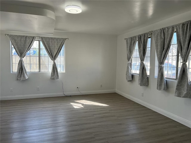 spare room with dark hardwood / wood-style flooring