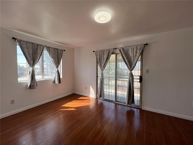 unfurnished room with hardwood / wood-style flooring