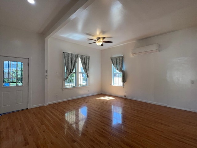 entryway with ceiling fan, wood-type flooring, and a wall mounted AC