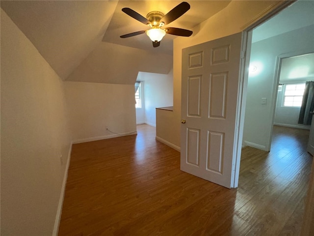 bonus room with ceiling fan, vaulted ceiling, and wood-type flooring