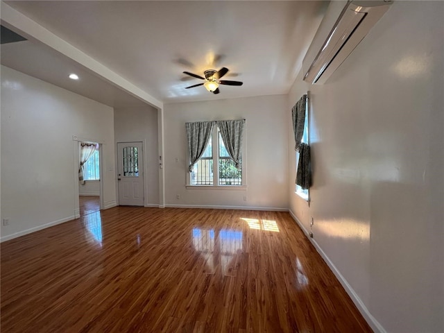 spare room featuring dark wood-type flooring and ceiling fan