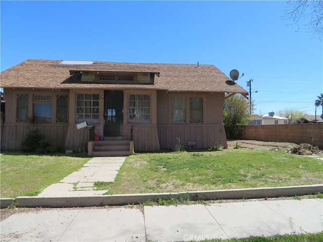 bungalow featuring a front yard and a porch