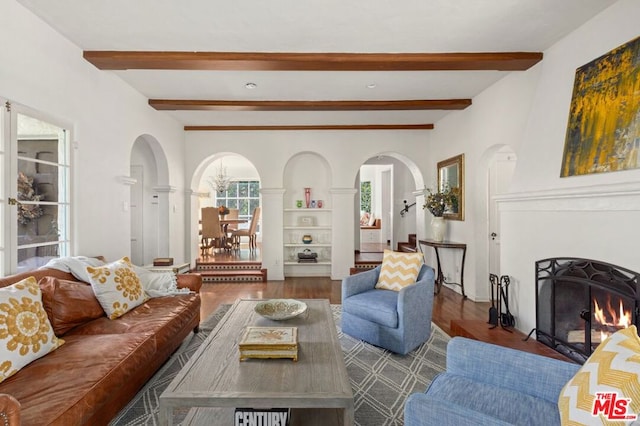 living room with beamed ceiling and dark hardwood / wood-style floors