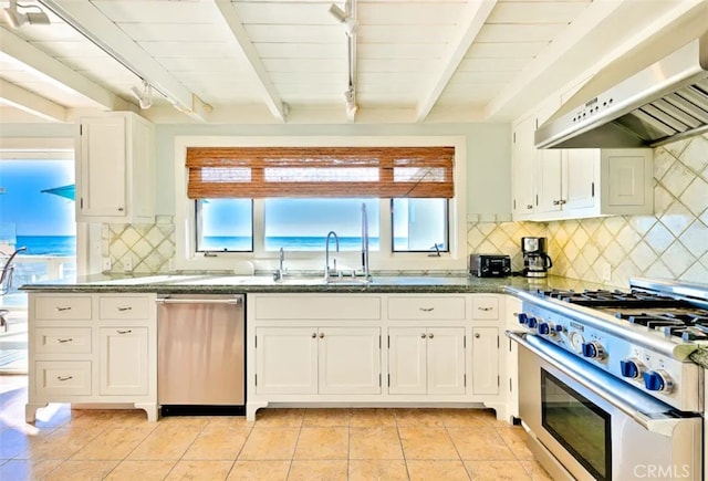 kitchen featuring white cabinets, beamed ceiling, extractor fan, and appliances with stainless steel finishes