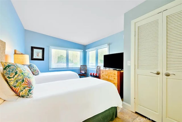 bedroom featuring a closet and lofted ceiling