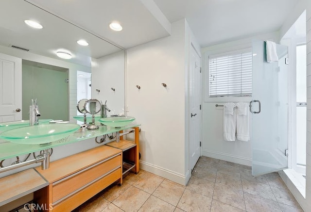 bathroom featuring tile patterned floors, vanity, and a shower with shower door