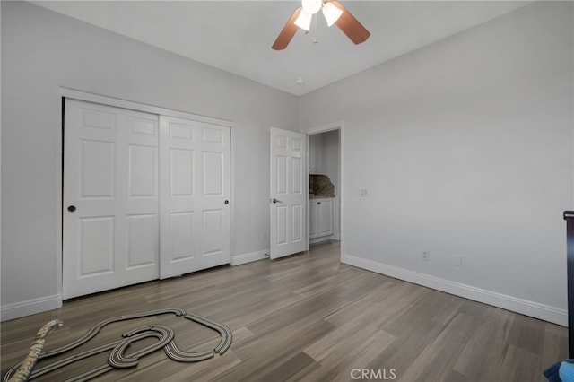 unfurnished bedroom with ceiling fan, a closet, and light hardwood / wood-style floors