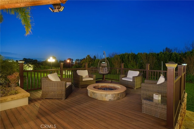 wooden deck featuring an outdoor living space with a fire pit