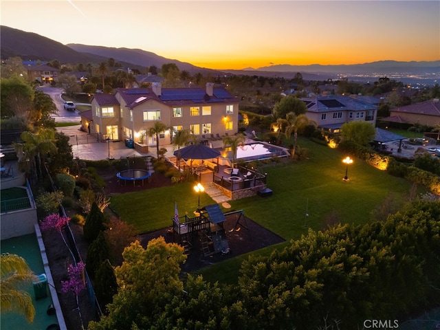 aerial view at dusk featuring a mountain view