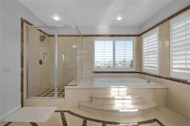 bathroom featuring shower with separate bathtub