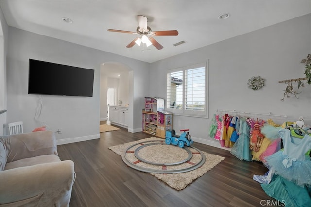 playroom featuring ceiling fan and dark wood-type flooring