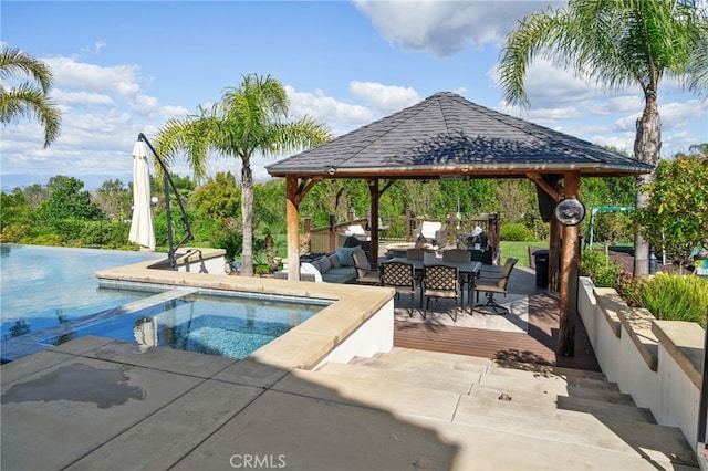 view of swimming pool with a gazebo, an in ground hot tub, and a patio