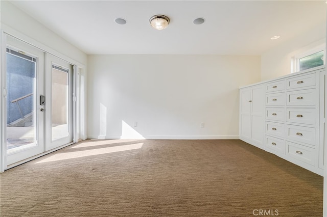 carpeted spare room featuring a wealth of natural light